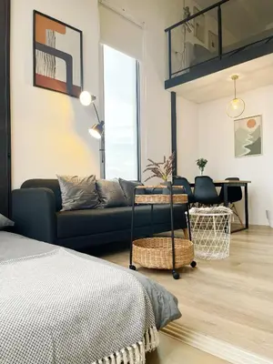 a living room with a couch and a table at 2BR BTS On Nut Siamese87 Two Bedroom LOFT hight floor 24 in Bangkok
