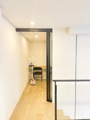a hallway with a table and a chair in a room at 2BR BTS On Nut Siamese87 Two Bedroom LOFT hight floor 24 in Bangkok