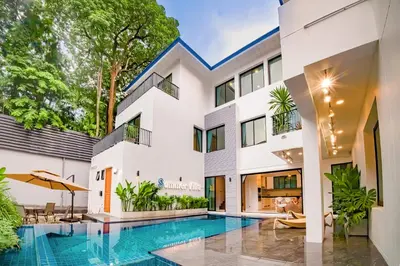 an exterior view of a house with a swimming pool at 943summer villa曼谷中心Asok&Tong lor800平海天别墅 in Bangkok