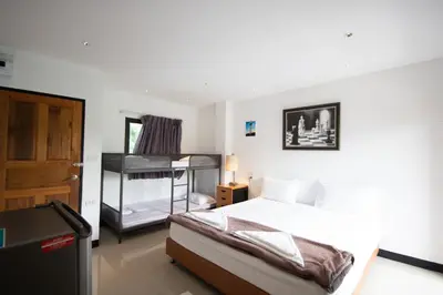 a bedroom with a bed and a bunk bed at Arttra Villa in Bang Chak