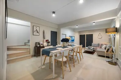 a dining room and living room with a table and chairs at 4BR house MRT subway 250m Chatujak Market wi-fi in Bangkok