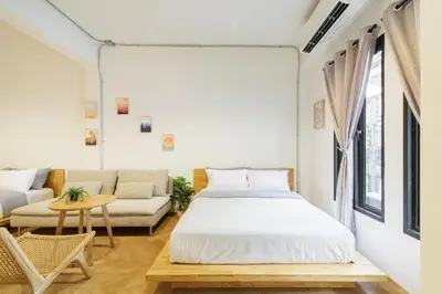 a bedroom with a bed and a couch at Wabisabi Bangkok 3 MIN To Train Station in Bangkok