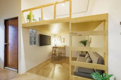 a room with a loft bed and a desk at Wabisabi Bangkok 3 MIN To Train Station in Bangkok