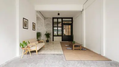 a living room with a couch and a table at Wabisabi Bangkok 3 MIN To Train Station in Bangkok
