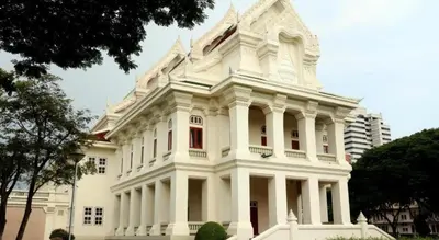 a large white building with red windows at Sleep cafe @ Hidee in Bangkok