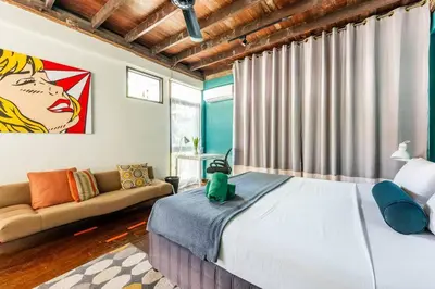 a bedroom with a large bed and a couch at Sleepinn Bang Chak in Bangkok