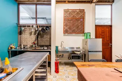 a kitchen with a counter and a refrigerator at Sleepinn Bang Chak in Bangkok