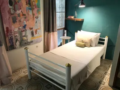 a bedroom with a bed with a teddy bear on it at Sleepinn Bang Chak in Bangkok