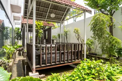 a porch of a house with trees and plants at BUA Suite Sukhumvit, Nana BTS in Bangkok