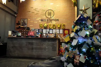 a christmas tree with ornaments on it in a store at BED STATION Hostel Ratchthewi in Bangkok