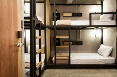 a room with four bunk beds in a room at BED STATION Hostel Ratchthewi in Bangkok