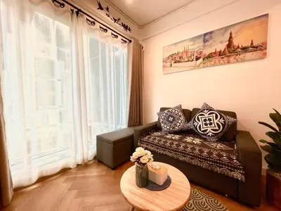 a living room with a couch and a table at Great relaxing in oldtown, Entire floor, near Grand Palace in Bangkok