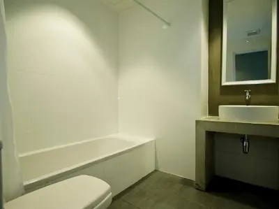a bathroom with a toilet and a sink at DI Place in Bangkok