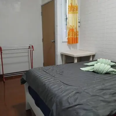 a bedroom with a bed with a pillow on it at Sleep at home hostel in Bangkok