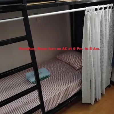 a bunk bed in a room with a ladder at Sleep at home hostel in Bangkok