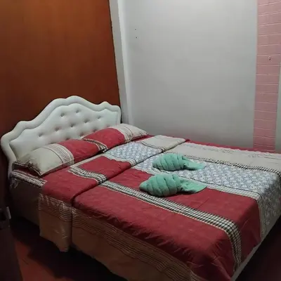 a bed with two pillows on top of it at Sleep at home hostel in Bangkok