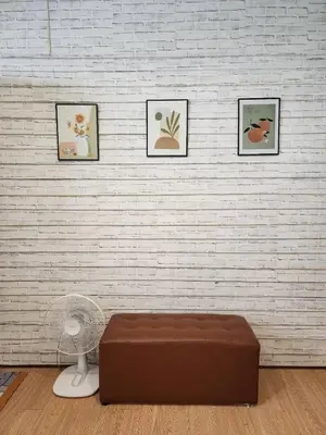 a room with a couch and three pictures on a wall at 207-Olan Place Homely room Free Wi-Fi and Near BTS line in Bangkok