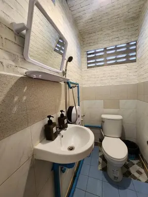 a bathroom with a white toilet and a sink at 207-Olan Place Homely room Free Wi-Fi and Near BTS line in Bangkok