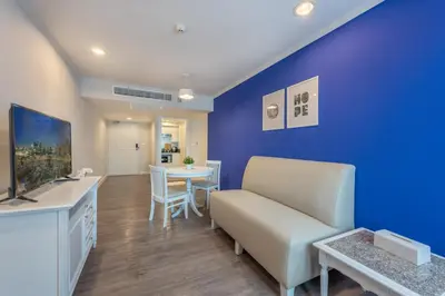 a living room with a couch and a table at Neom Town Residence in Bangkok