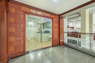a new town store front door with a new town sign at Neom Town Residence in Bangkok