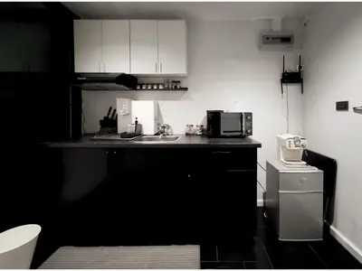 a black and white kitchen with a sink and a microwave at Luxe Design l Wellness & Tropical Retreat l No fee in Bangkok