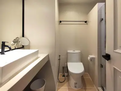 a bathroom with a white toilet and a sink at Luxe Design l Wellness & Tropical Retreat l No fee in Bangkok