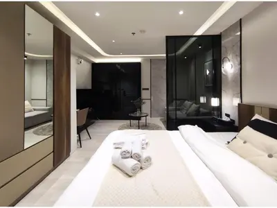 a bedroom with a large white bed with towels on it at Luxe Design l Wellness & Tropical Retreat l No fee in Bangkok
