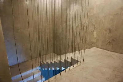 a shower in a room with wooden walls at Silom Soi 3 Hash Apartment in Bangkok