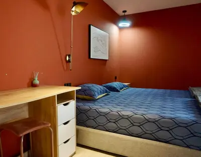 a bedroom with a bed and a desk in it at Silom Soi 3 Hash Apartment in Bangkok