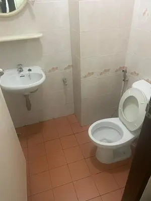 a bathroom with a toilet and a sink at Viriyapon first floor2 in Bangkok