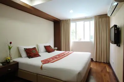 a hotel room with a large bed and a window at The Ninth Place Serviced Residence in Bangna