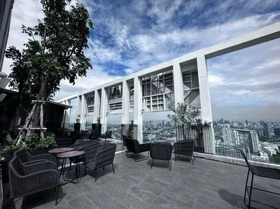a patio with chairs and tables on top of a building at S87-7052 BTS Onnut High Floor Gym Swim Good View in Bangkok