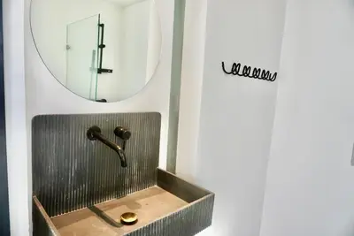 a bathroom with a sink and a mirror at Hash Apartment Silom Soi 3 - hip and funky with rooftop view in Bangkok