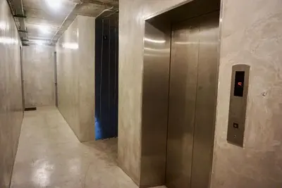 a hallway with a elevator in a building at Hash Apartment Silom Soi 3 - hip and funky with rooftop view in Bangkok
