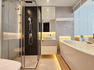 a bathroom with a shower and a sink and a toilet at The Address 28 in Bangkok