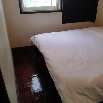 a white bed in a room with a window at Bangkok Dreamcatcher hostel in Bangkok