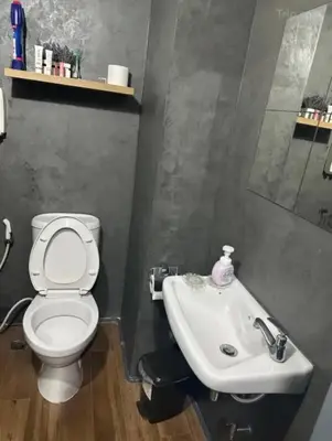 a bathroom with a toilet and a sink at Bangkok Chat box Hostel in Bangkok