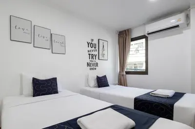 a room with two beds and a window at Nature Boutique Residence in Bangkok