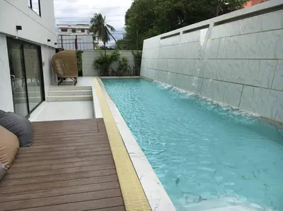 a swimming pool next to a building at The Forest Building A-more than3nights stay-self checkin checkout in Bangkok