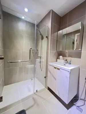 a bathroom with a shower and a sink and a mirror at The Forest Building A-more than3nights stay-self checkin checkout in Bangkok