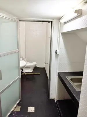 an empty bathroom with a toilet and a sink at The Character China Town เดอะ คาแรคเตอร์ เยาวราช Mrt วัดมังกร Pro in Khlong San