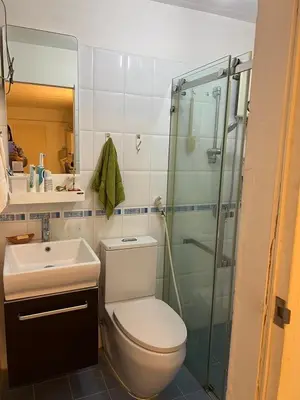a bathroom with a toilet and a sink and a shower at Mahasap Ramindhra next to MRT Station in Bang Khen