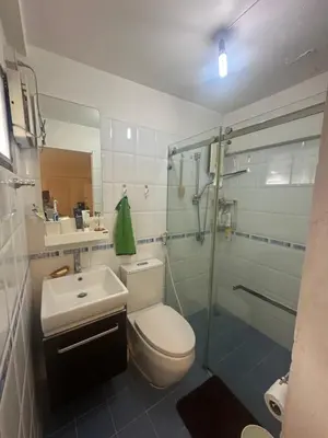 a bathroom with a toilet and a sink and a shower at Mahasap Ramindhra next to MRT Station in Bang Khen