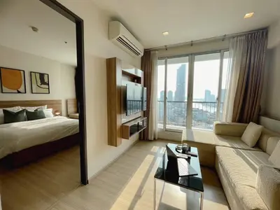 a hotel room with a bed and a large window at Luxurious Downtown River View chao phraya river in Bangkok