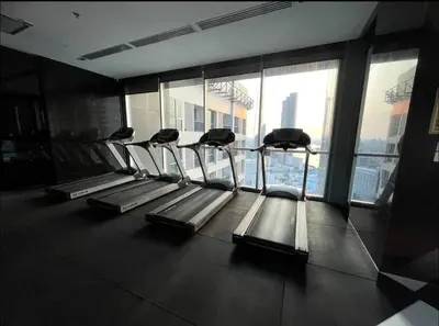 a gym with a row of treadmills in a building at Luxurious Downtown River View chao phraya river in Bangkok