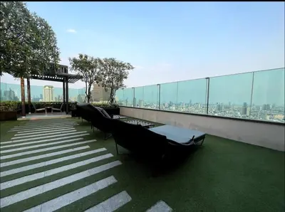 a balcony with tables and chairs on top of a building at Luxurious Downtown River View chao phraya river in Bangkok