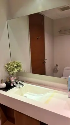 a bathroom with a sink and a large mirror at Sam Homestay in Bangkok
