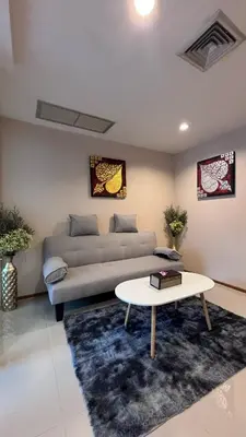 a living room with a couch and a table at Sam Homestay in Bangkok