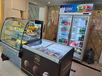 a food cart in a store with a refrigerator at Sam Homestay in Bangkok