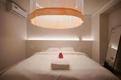 a bedroom with a bed with towels on it at ABC Bangkok RCA in Bangkok